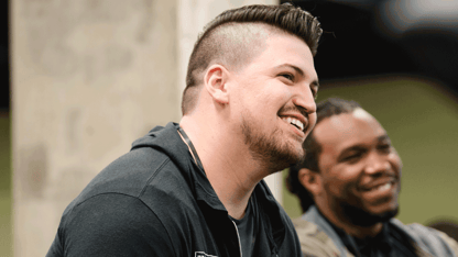 Two men smiling