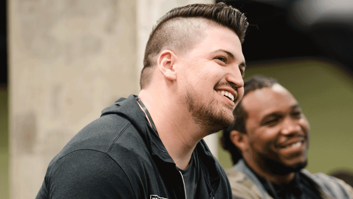 Two men smiling