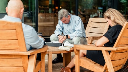 Group of adults sitting together and praying