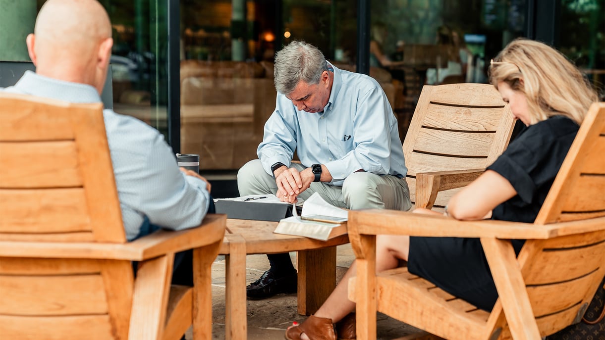 Group of adults sitting together and praying