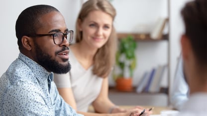 A man and women sit together in a meeting