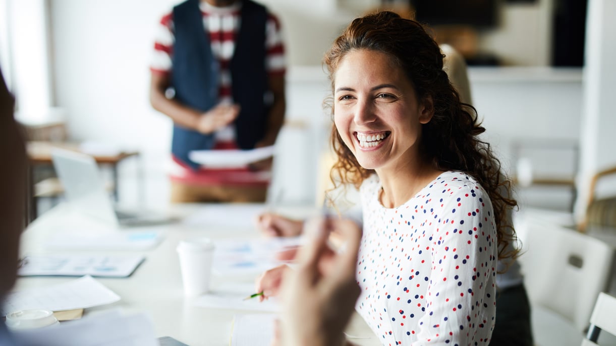 A woman sits in a work meeting