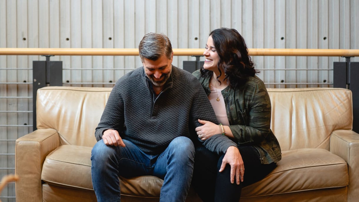 A couple sits on a couch together