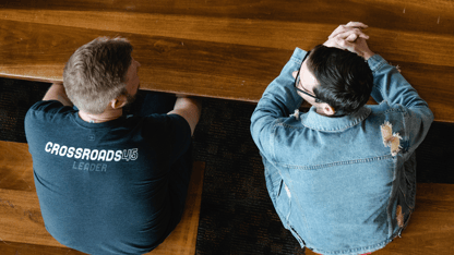 2 men sitting in a church pew