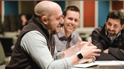 A group of men sitting together in a meeting