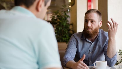 Two men speaking with one another