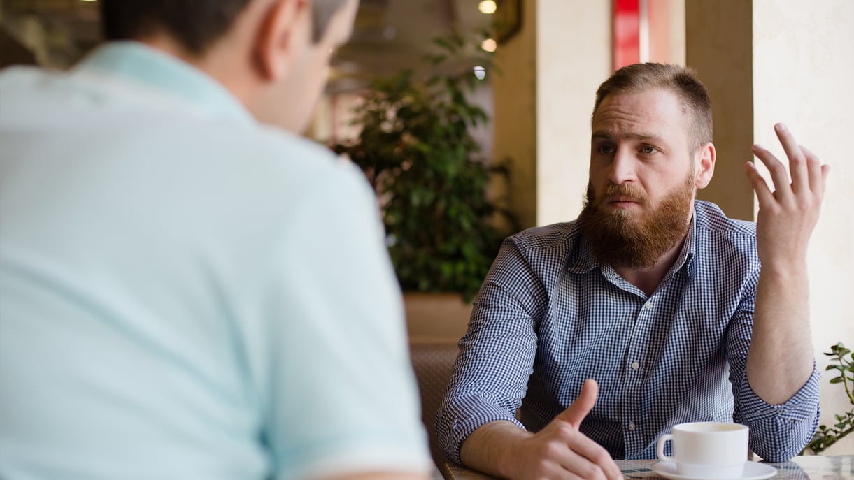 Two men speaking with one another
