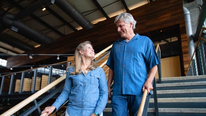 A couple walking down a flight of stairs