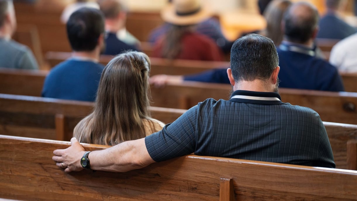 A couple sitting together in church