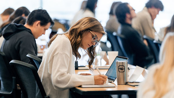 Watermark Institute fellow writing in class