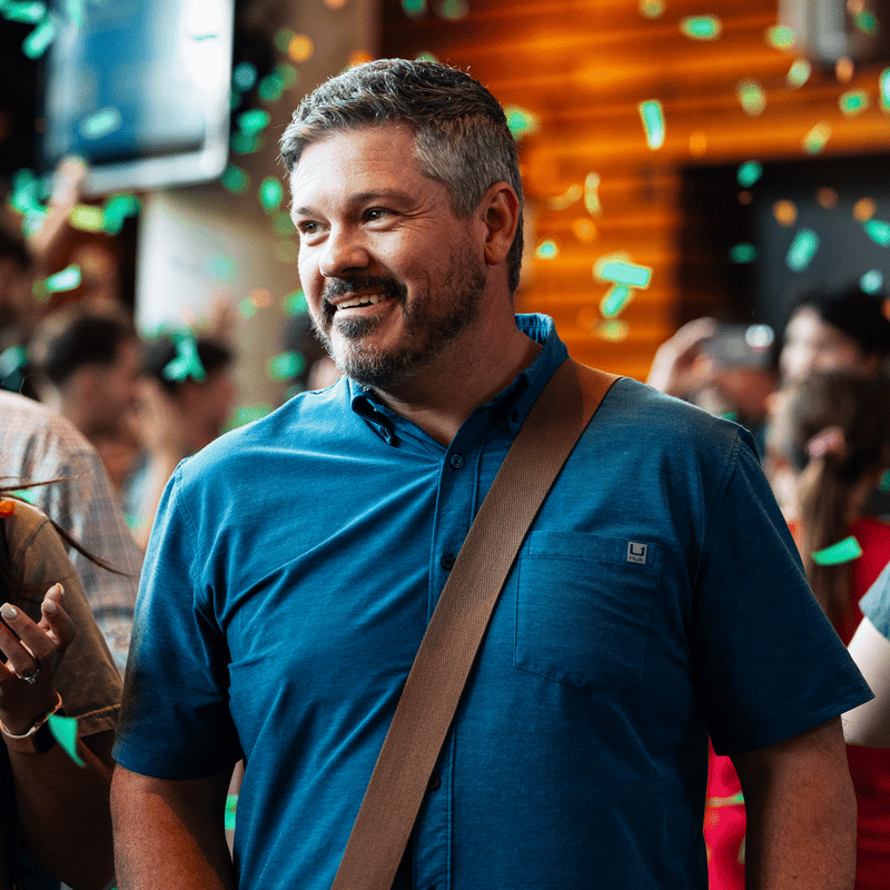 Man smiling at Watermark Community Church with confetti behind him