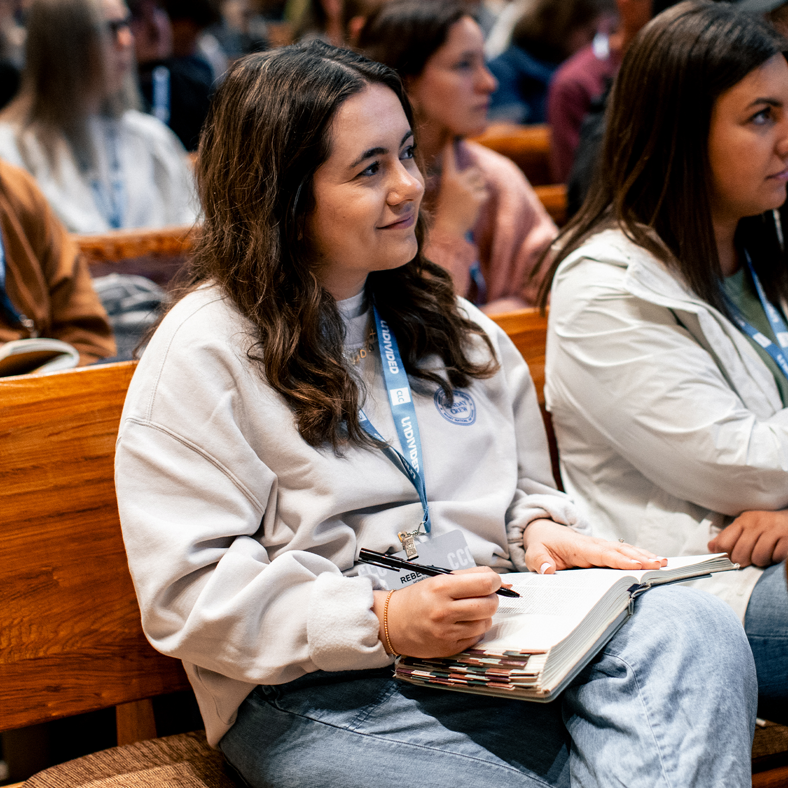 CLC woman attendee listening in a breakout session