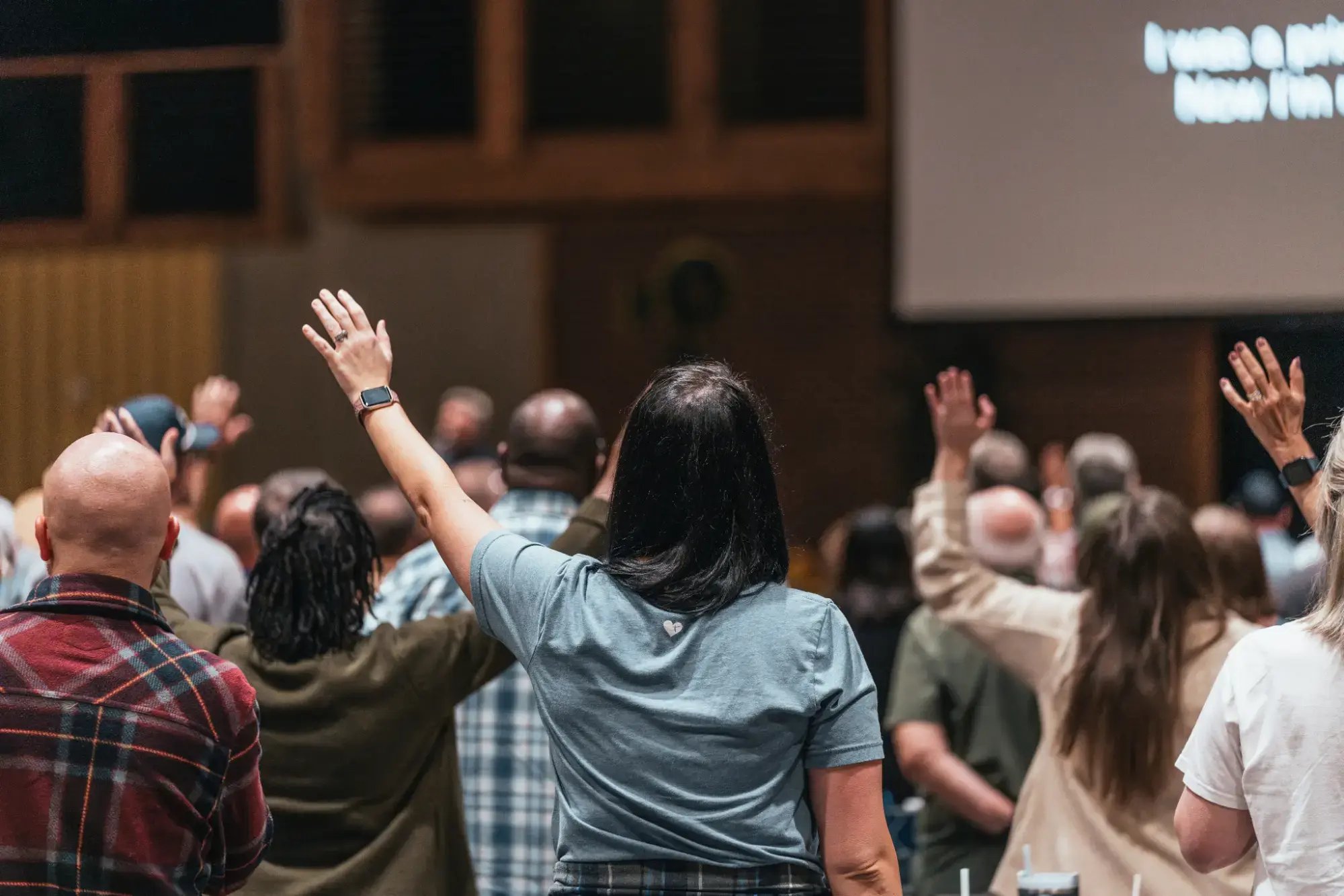 Congregation raising hands during a worship service