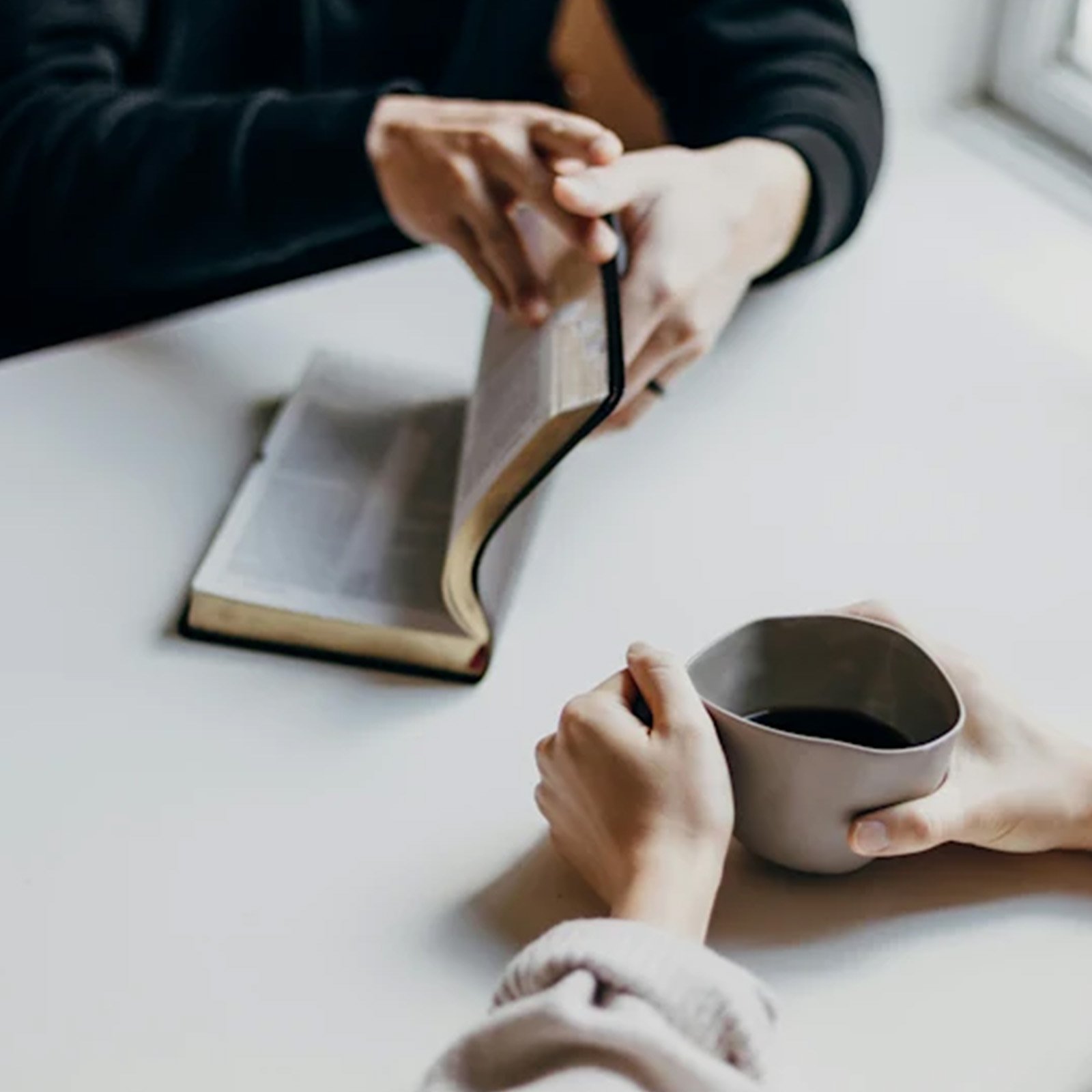 A person opening up their Bible