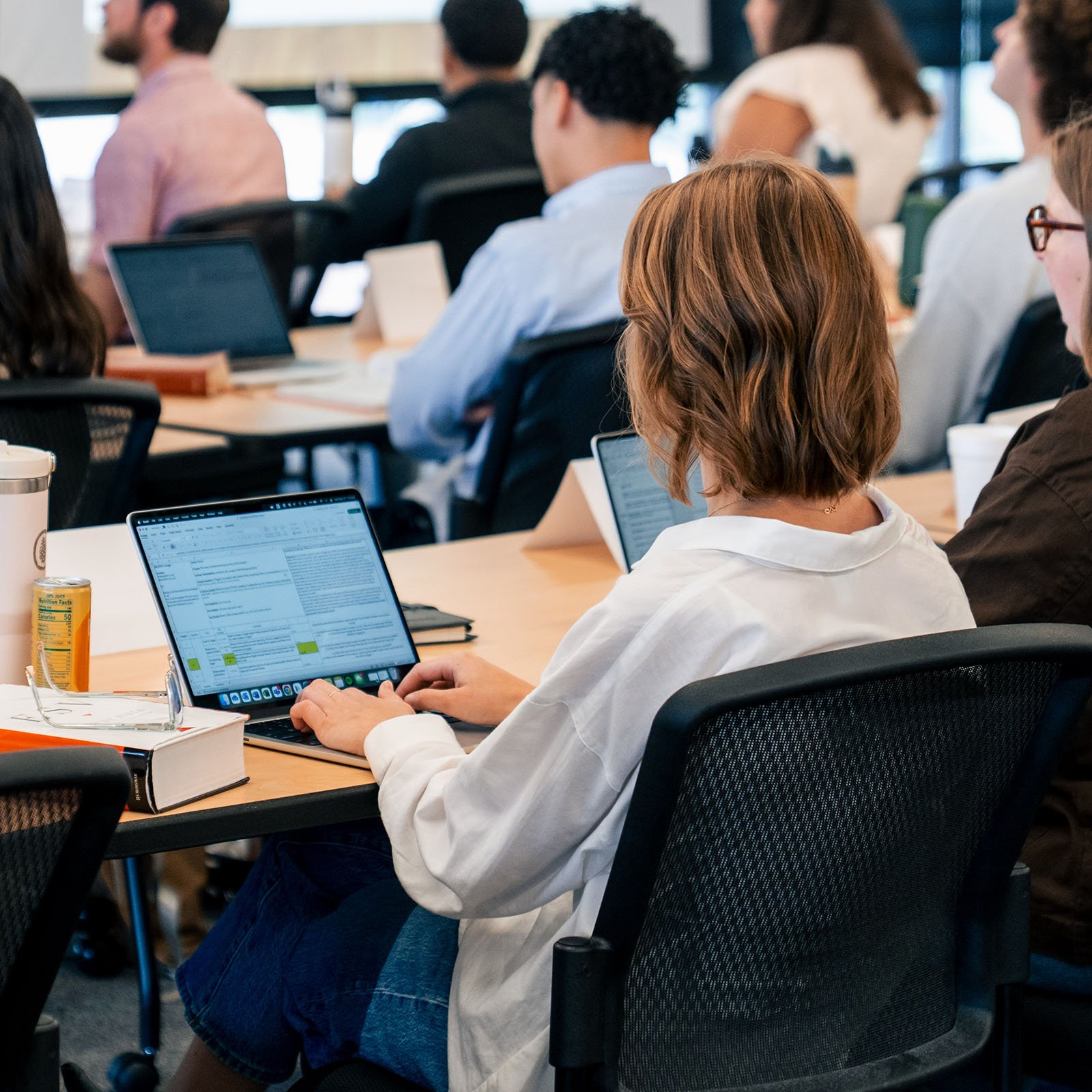 Watermark Institute student with her laptop taking notes