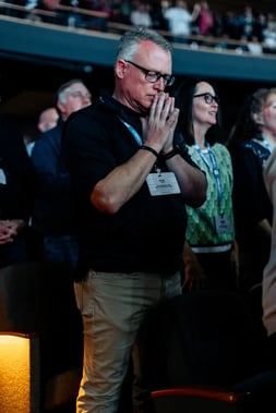 CLC conference attendee praying during worship