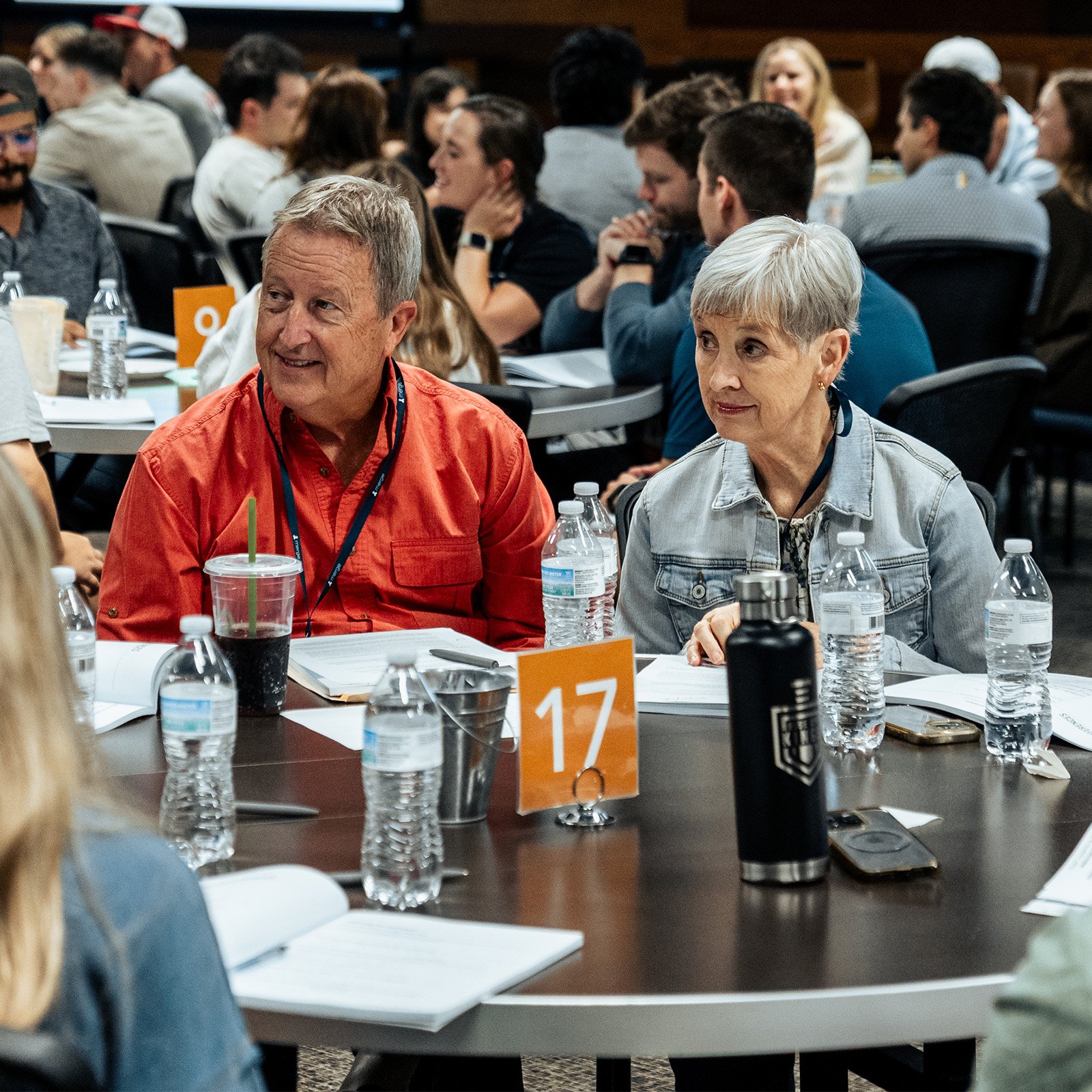 Merge leaders listening to participants at their table