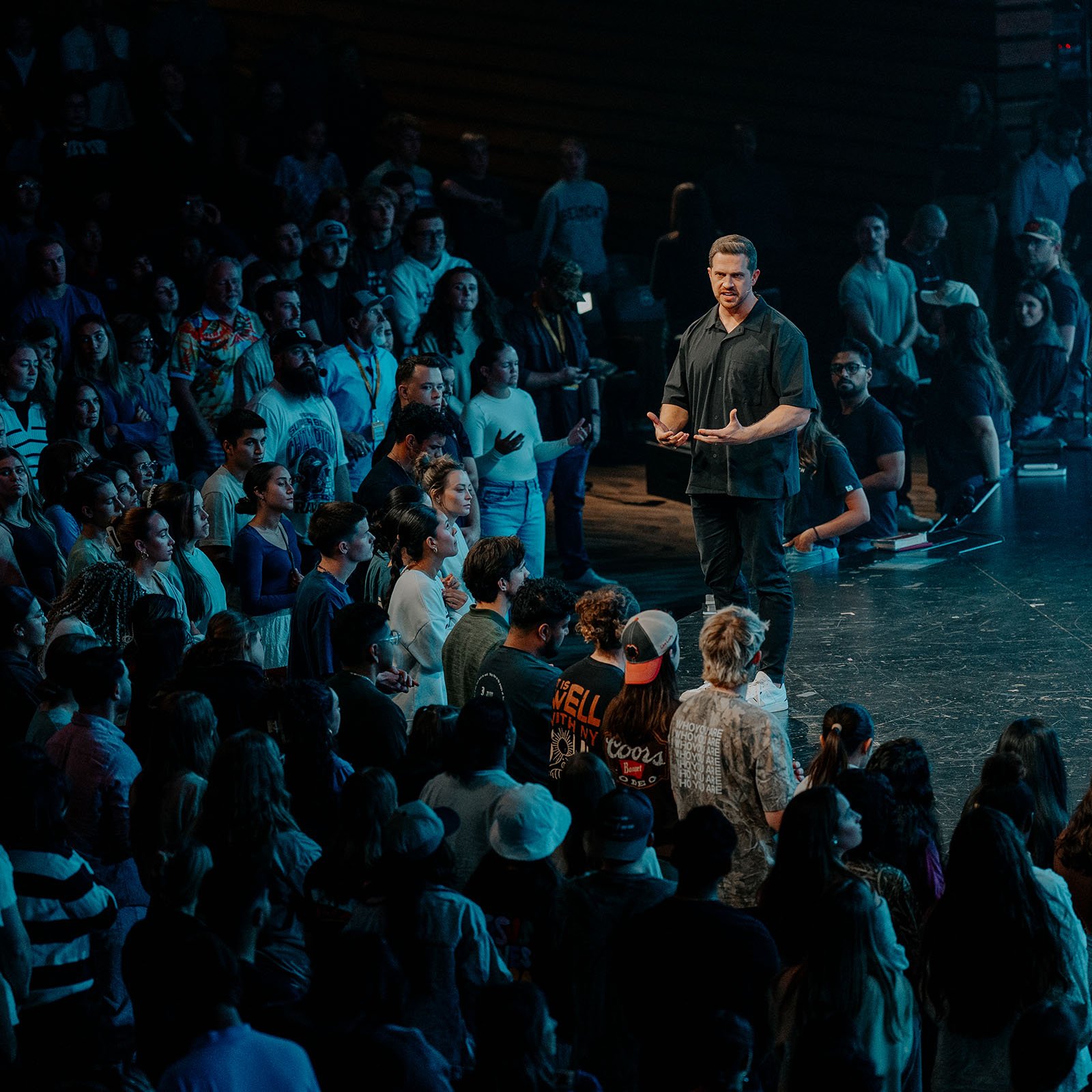 Young Adults Director of The Porch teaching from stage