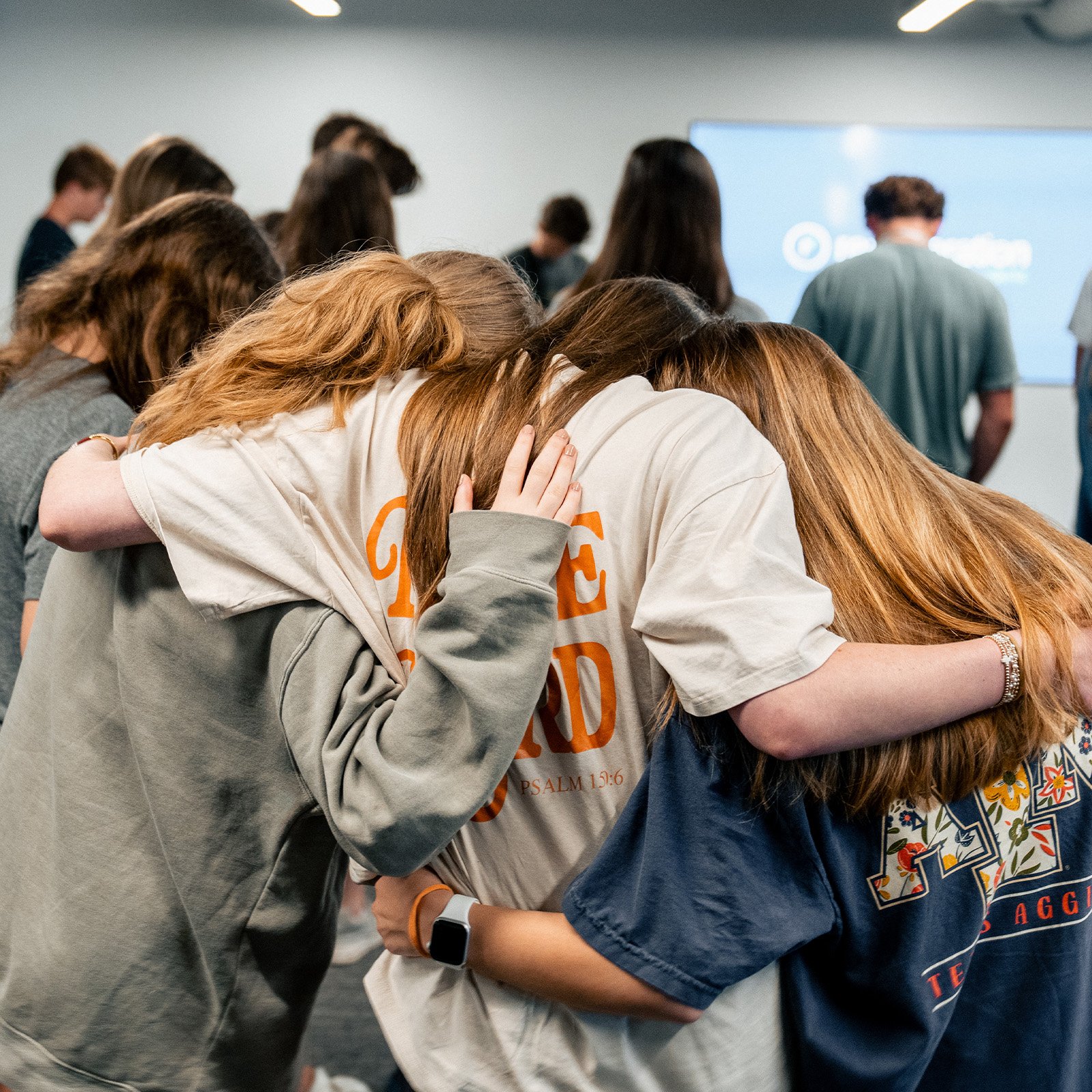 Female students bowing heads together