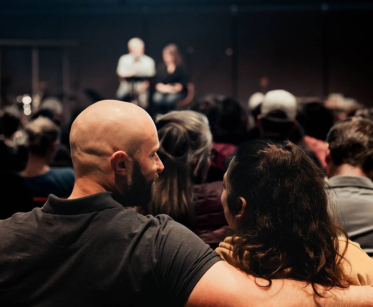 Married couple listening to the large group session at Re|engage