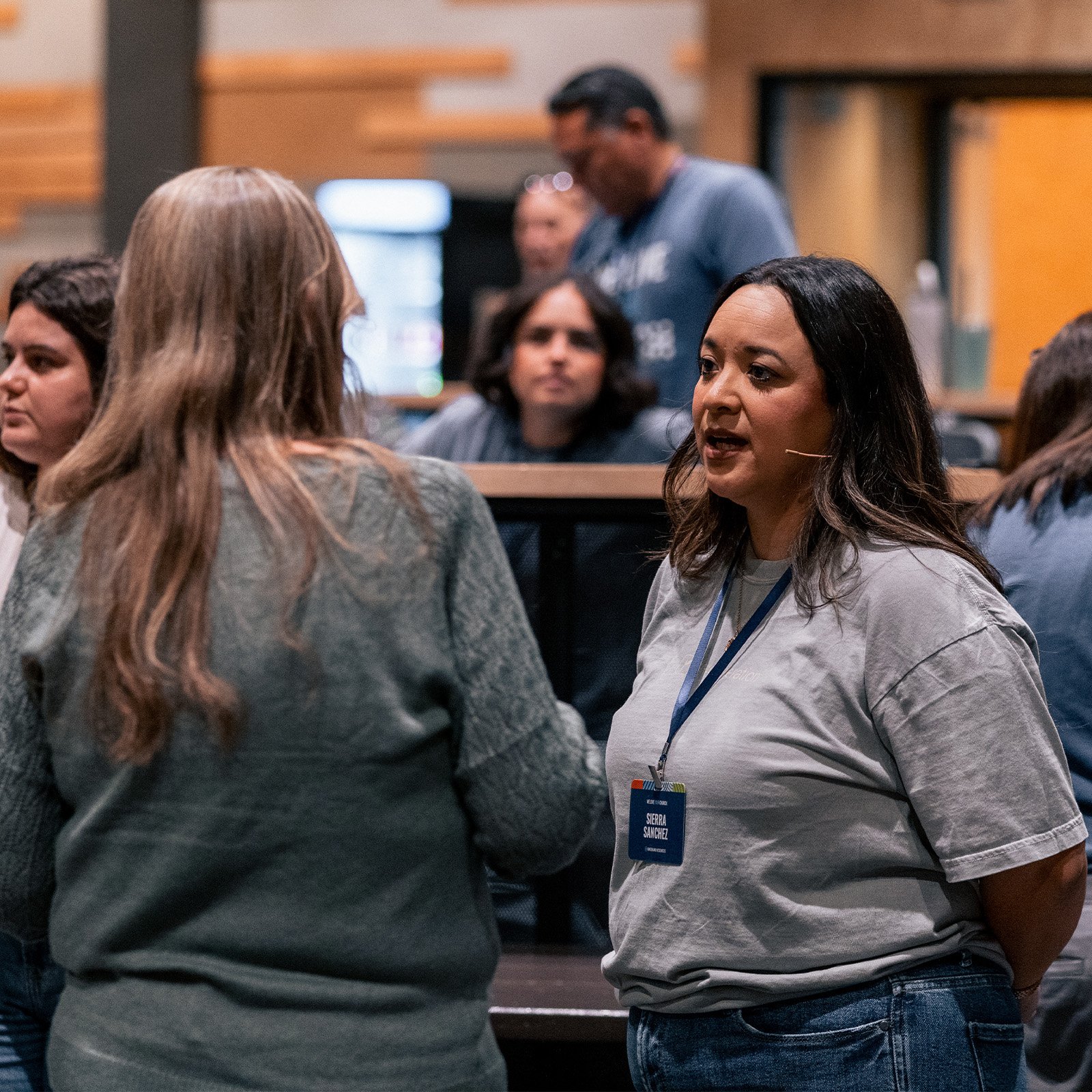 Director of Re:generation, Sierra Sanchez, talking with a conference attendee