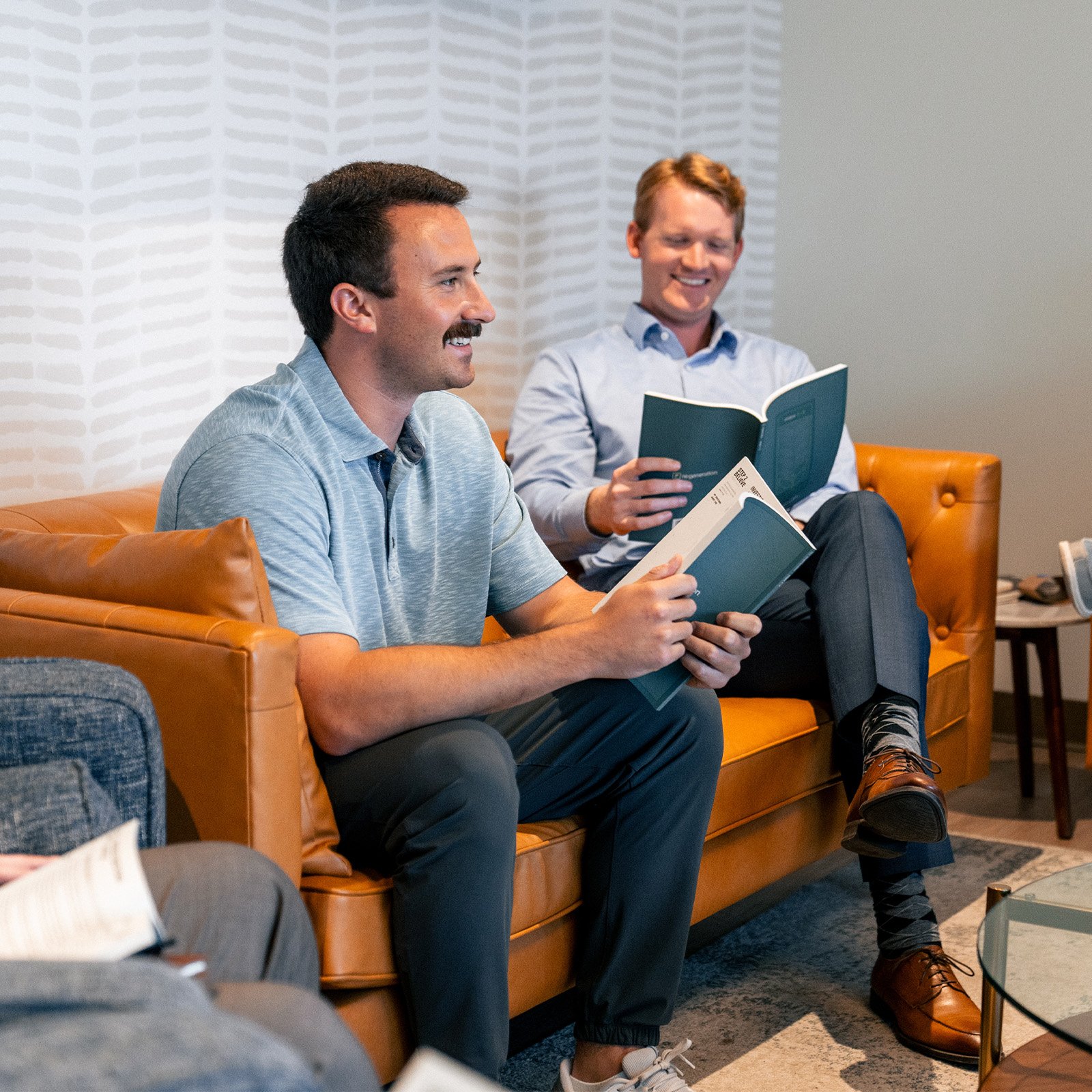 Two Re:generation male participants sharing in their small group
