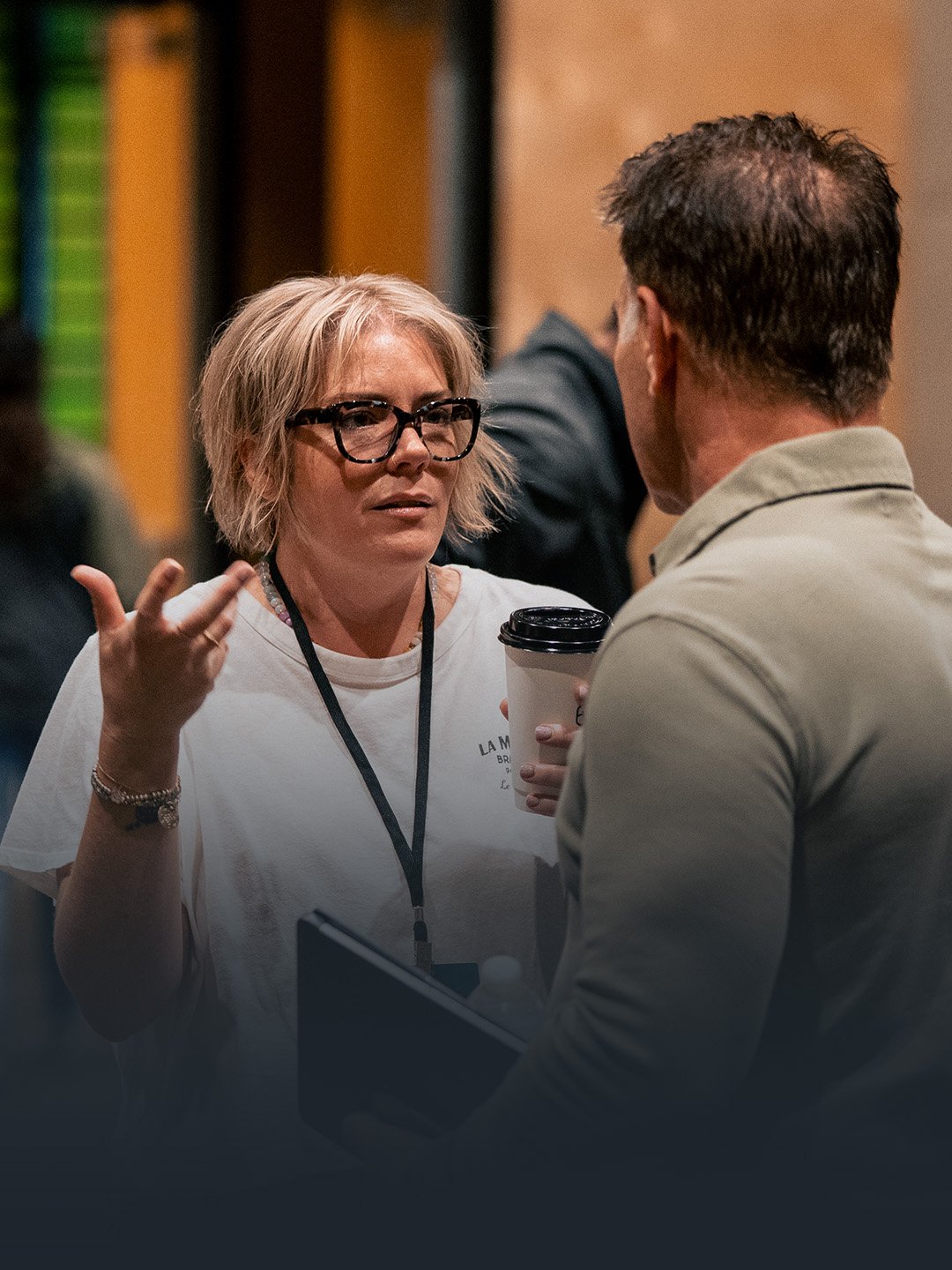 Re:generation female participant talking with another attendee