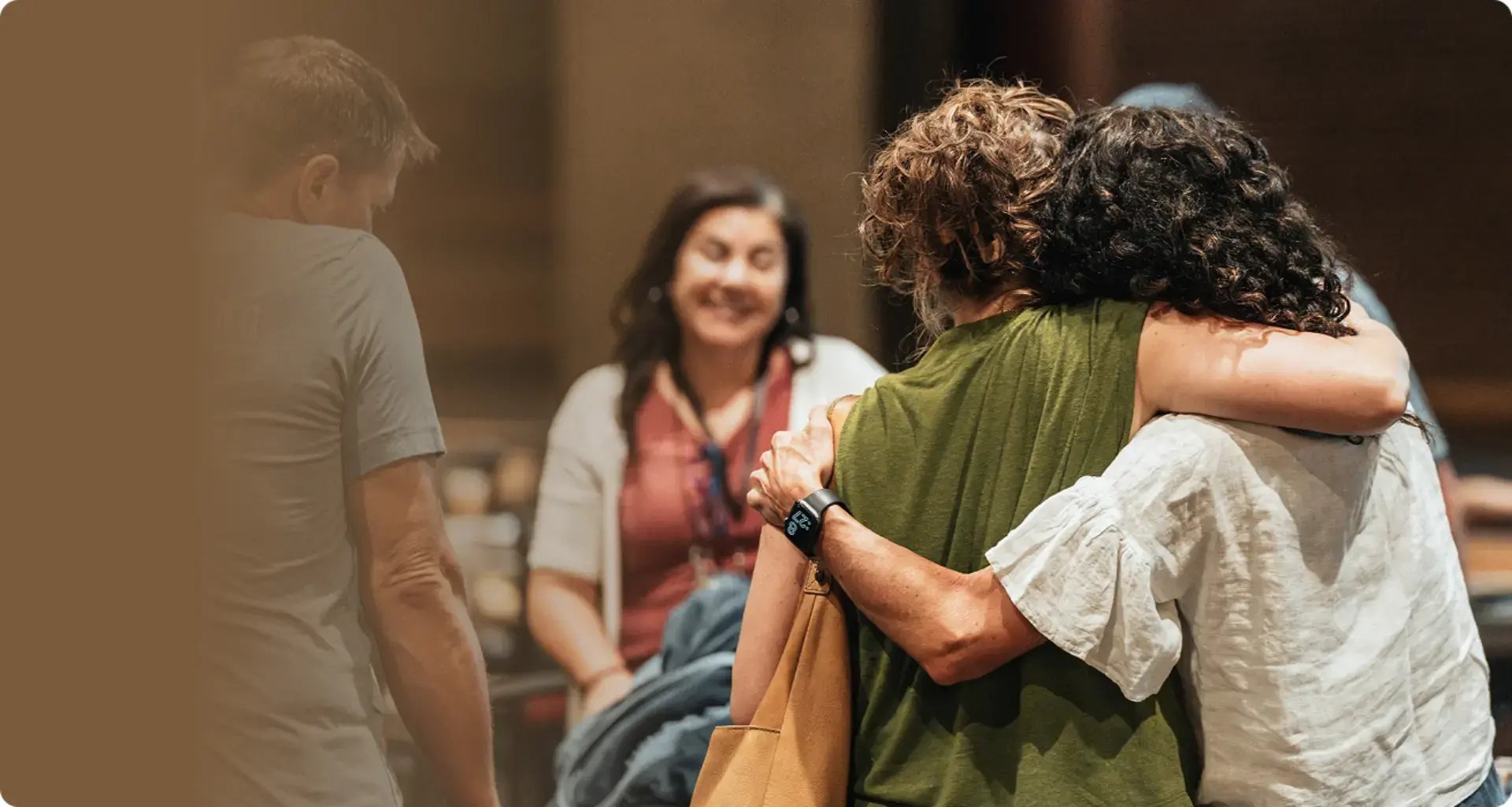 Two Re:generation female participants hugging at a conference