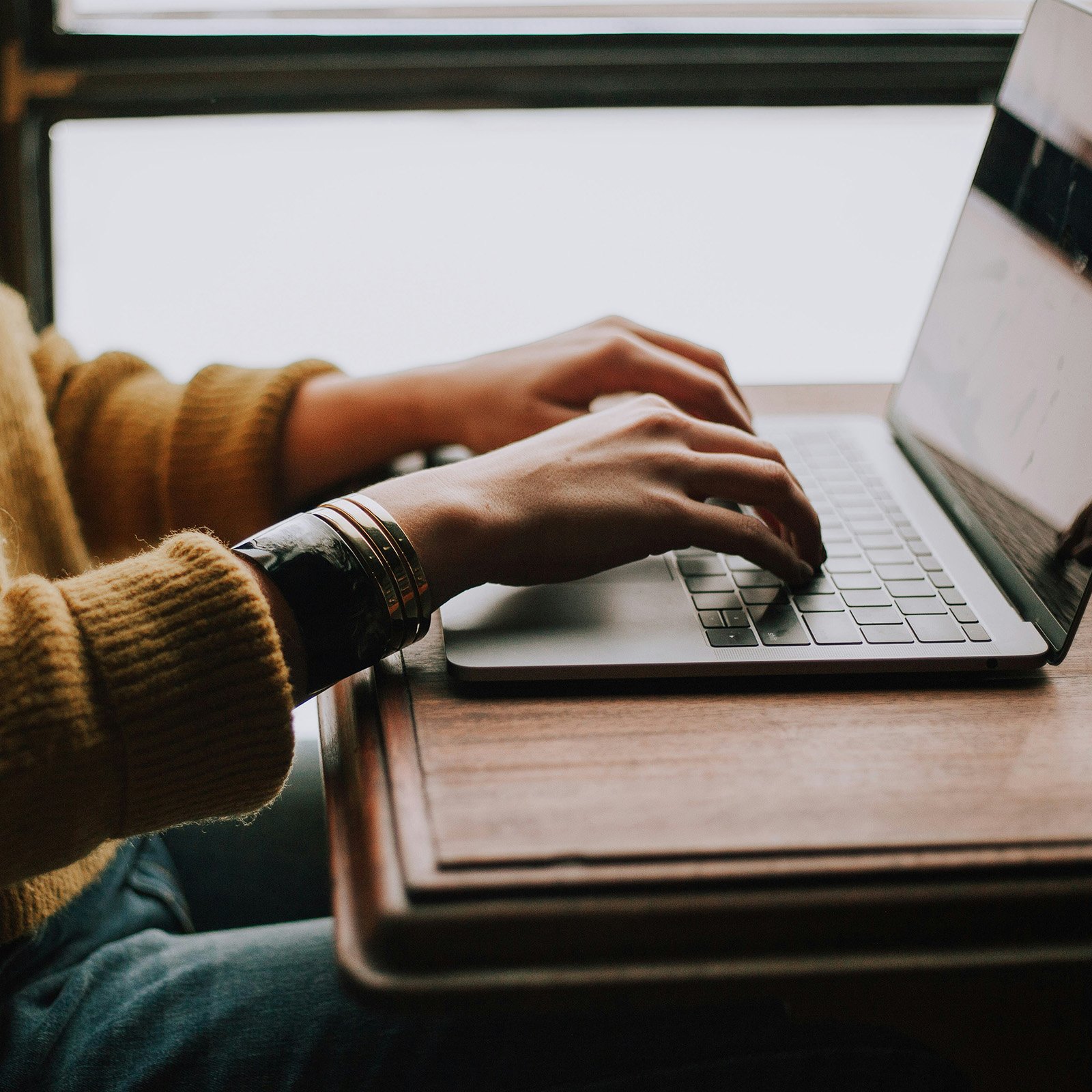 Person taking notes on a laptop