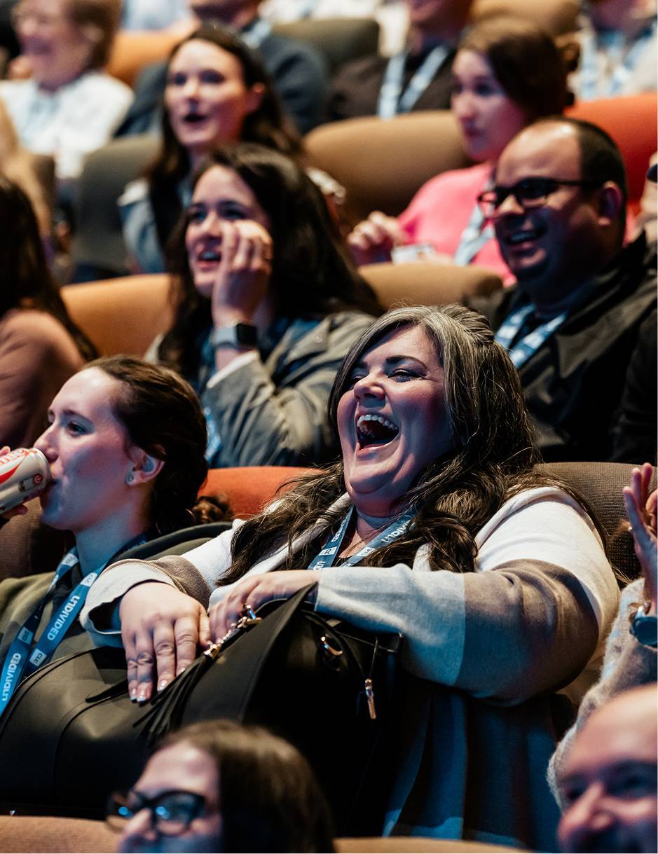 CLC conference attendee laughing during a mainstage session